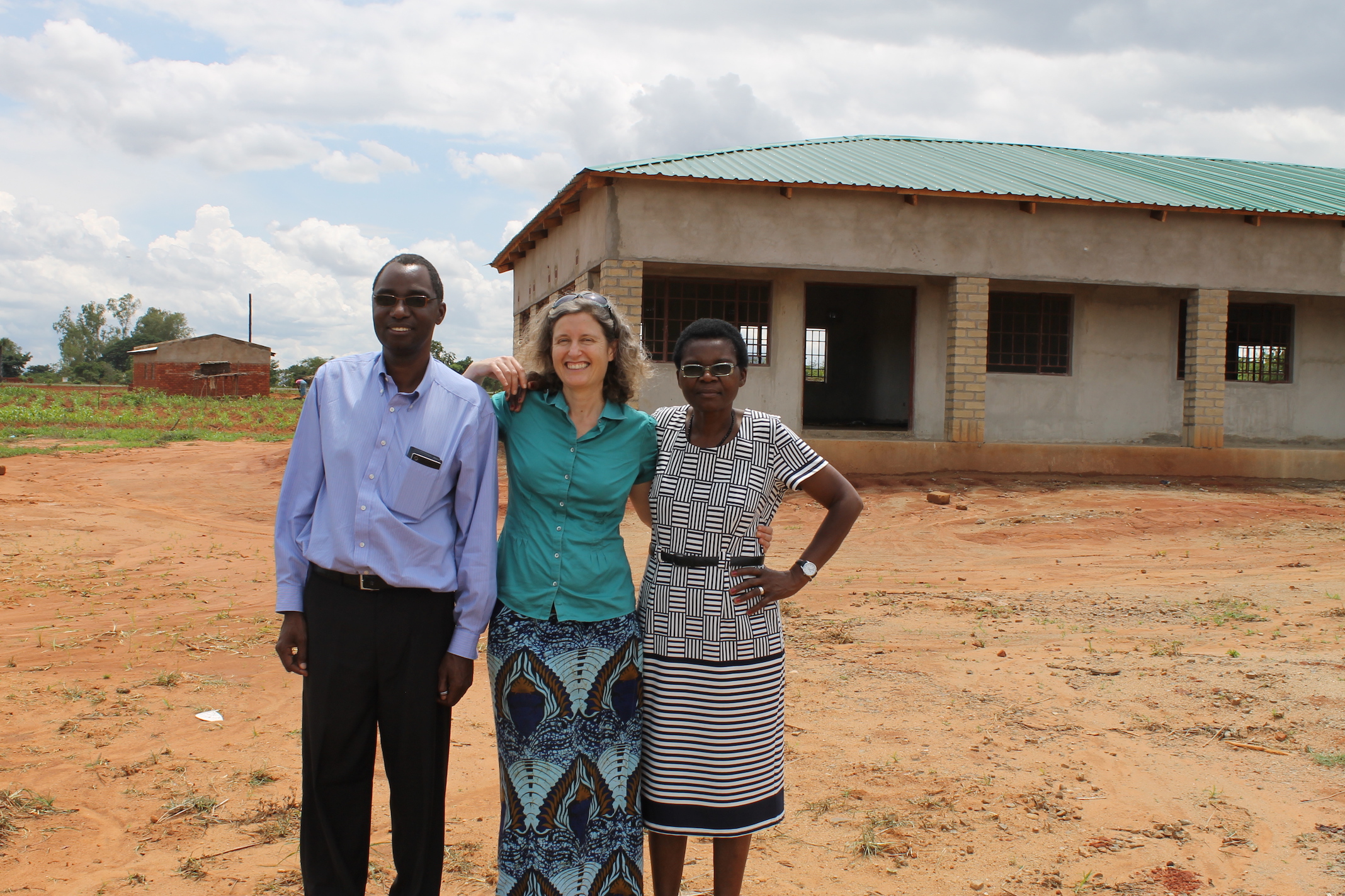 Esther Lupafya, Laifolo Dakishoni (members of SFHC) and Rachel Bezner Kerr (Friends of SFHC) standing in front of the Center.